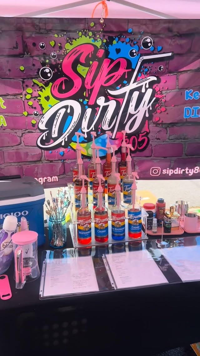 Sip Dirty 805 mobile pop-up bar setup with Torani syrup bottles and graffiti backdrop